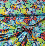 Viskosejersey Stoff - hellblaue und orangene Blüten, grüne Blätter auf dunkelblau