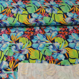 Viskosejersey Stoff - hellblaue und orangene Blüten, grüne Blätter auf dunkelblau